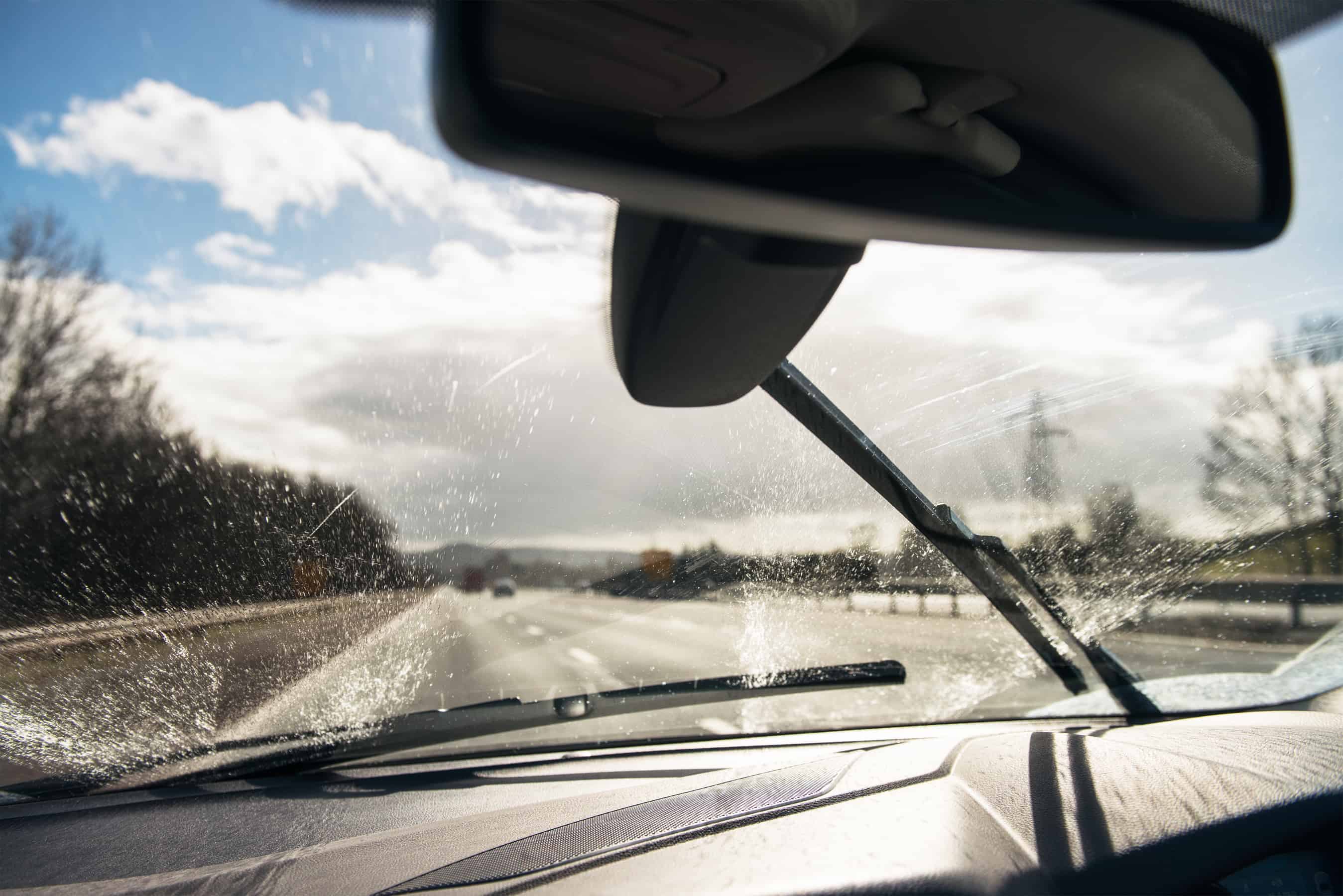 Squirting fluid on a car windscreen - World of Carwash